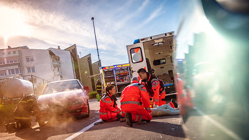 Highway car crash with injuries and paramedics at the scene